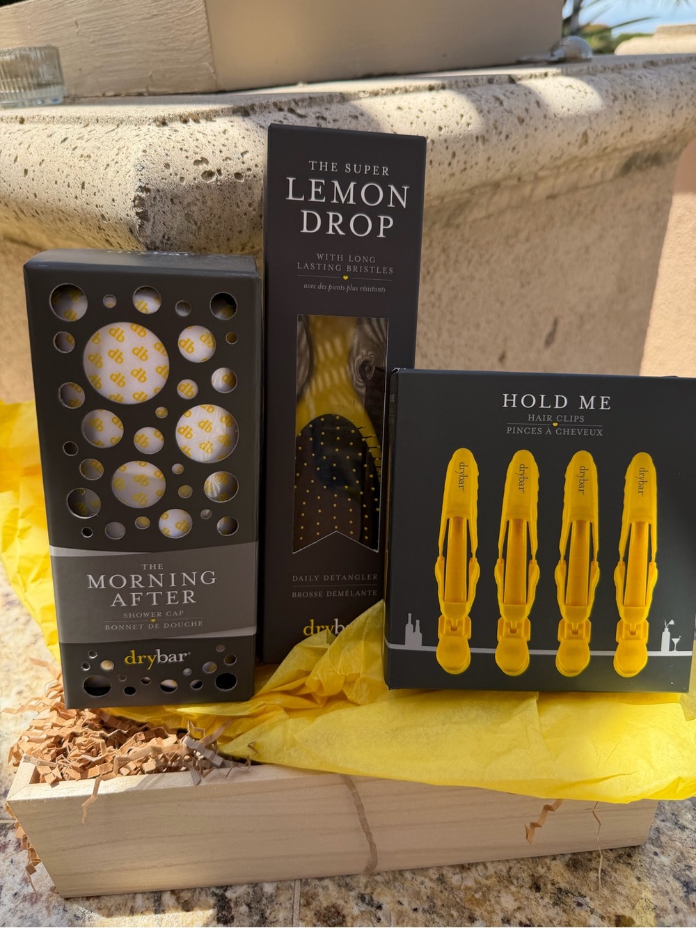 Drybar Lemon Drop Detangler Brush and Hold Me Clips ,and shower cap.